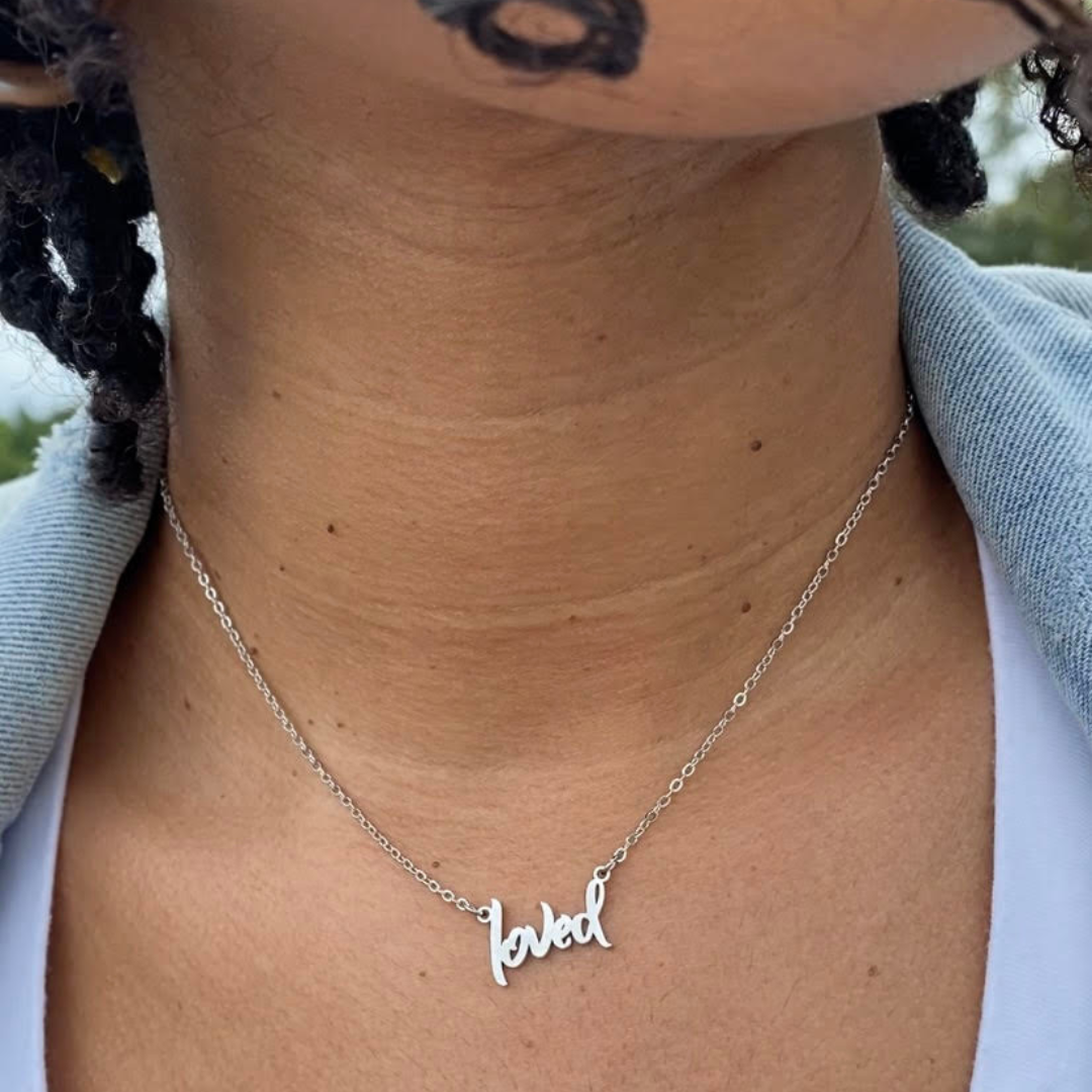 model wearing silver Loved affirmation necklace from Sol Rise Essentials