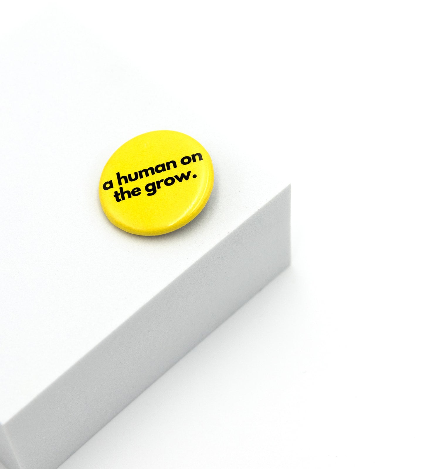 a human on the grow affirmation pin from Sol Rise Essentials yellow and black