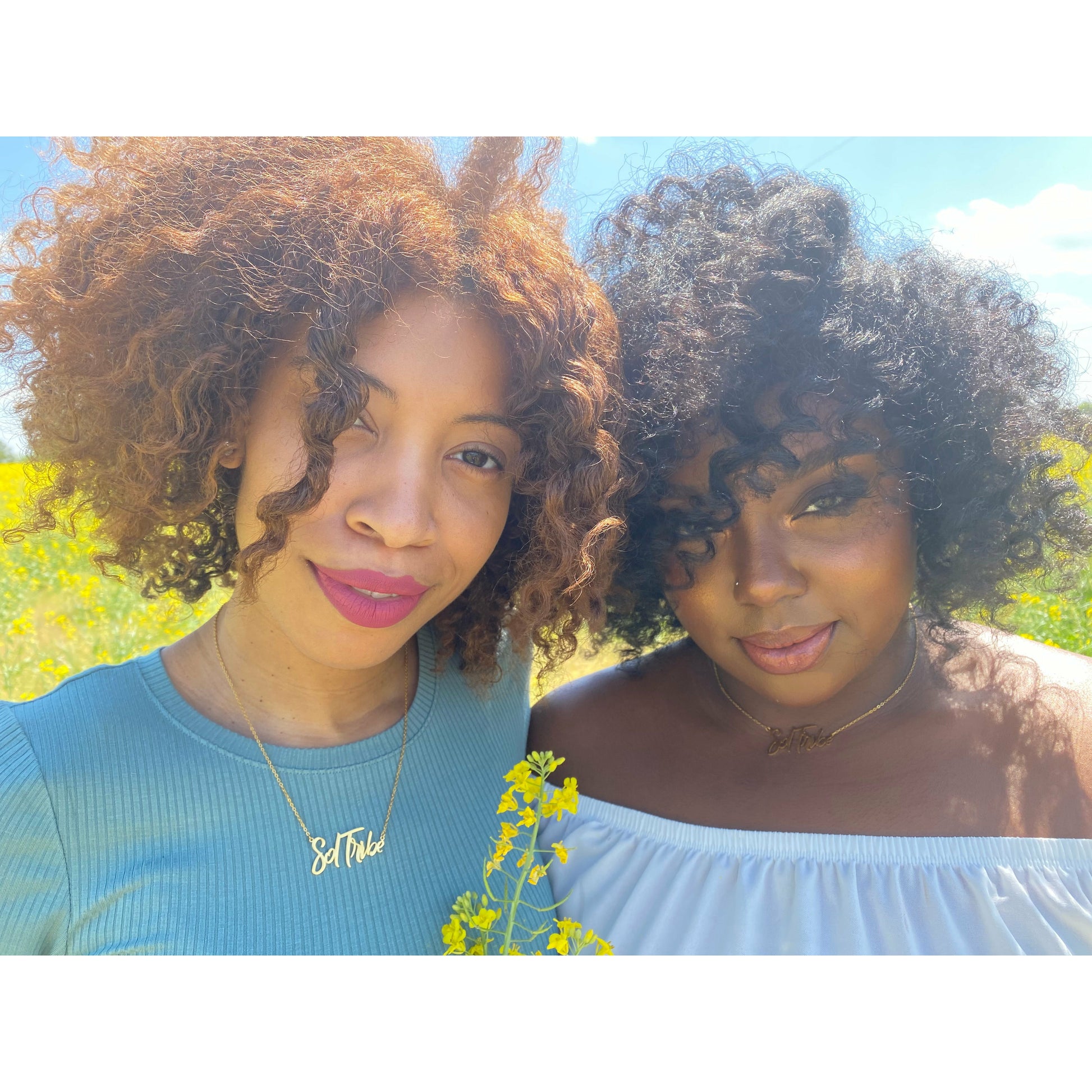Two women wearing Sol Tribe affirmation necklace in gold.