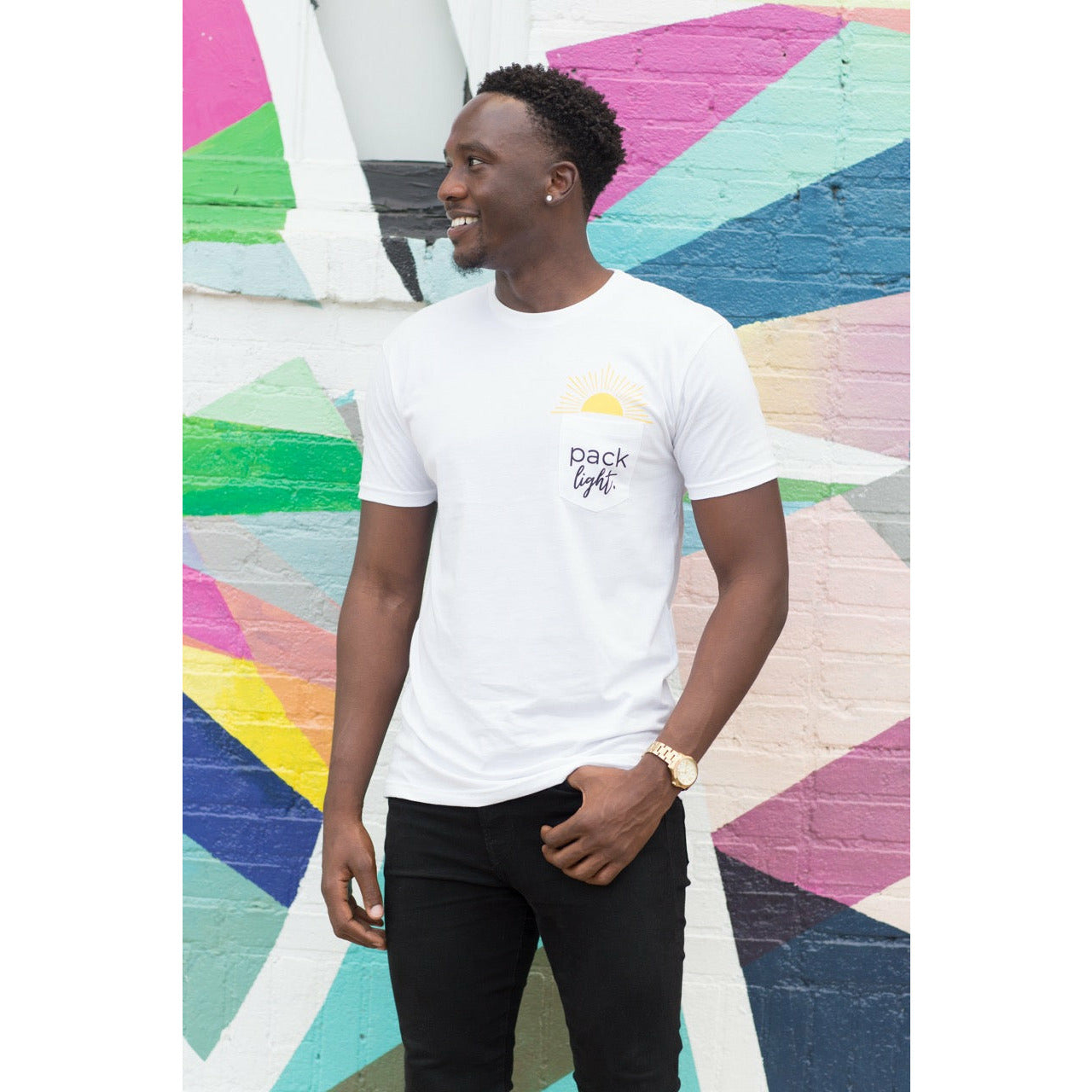 Smiling man wearing Pack Light affirmation t-shirt from Sol Rise Essentials