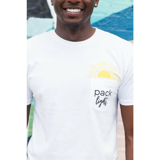 close up of smiling man wearing Pack Light affirmation tee with pocket and sunshine graphic emerging from it