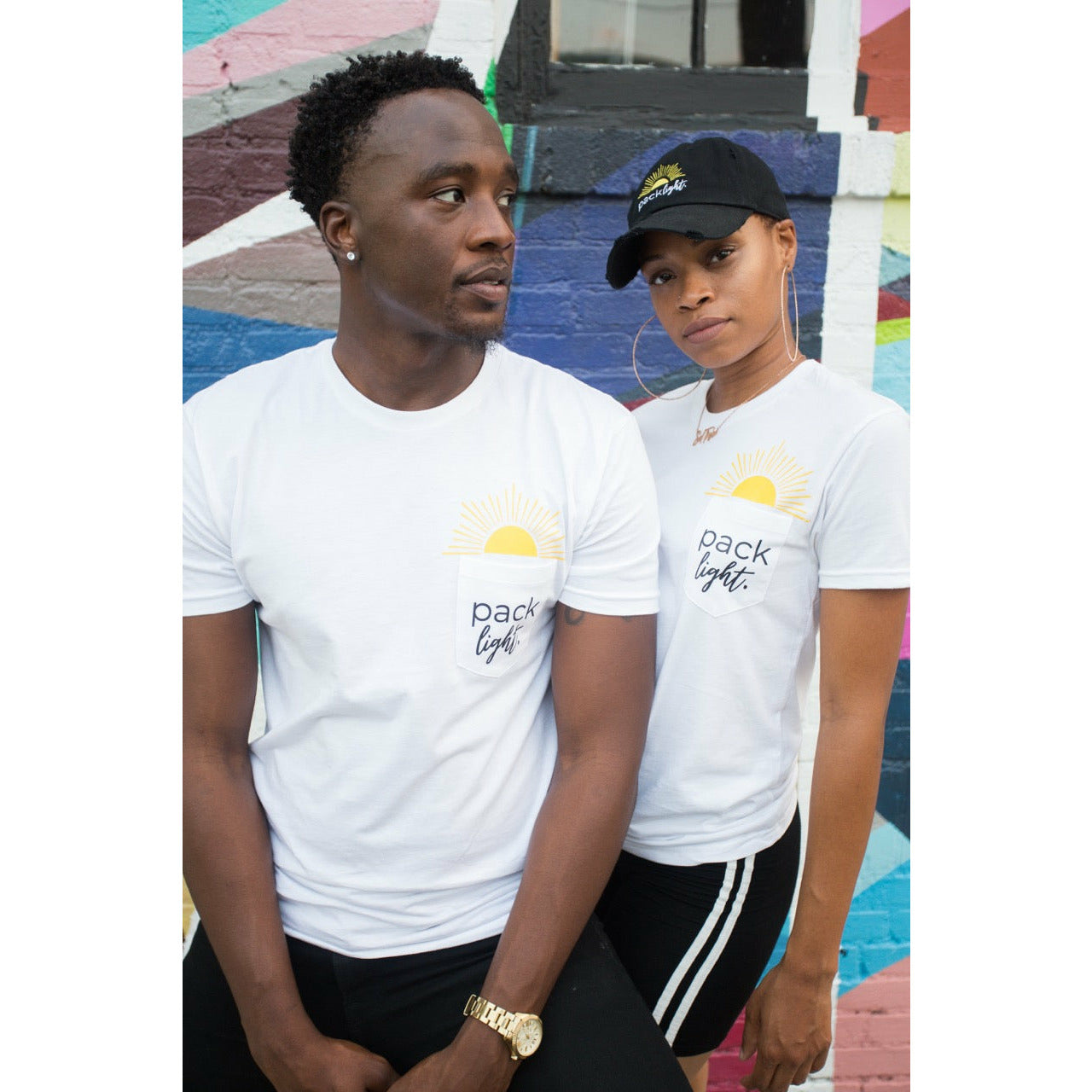 man and woman wearing Pack Light affirmation merchandise from Sol Rise Essentials