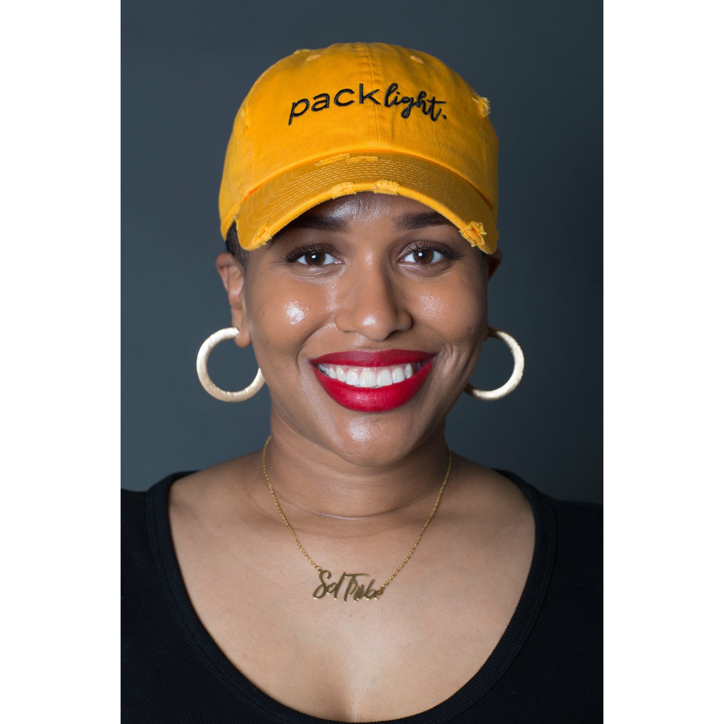 model wearing gold Pack Light affirmation hat from Sol Rise Essentials