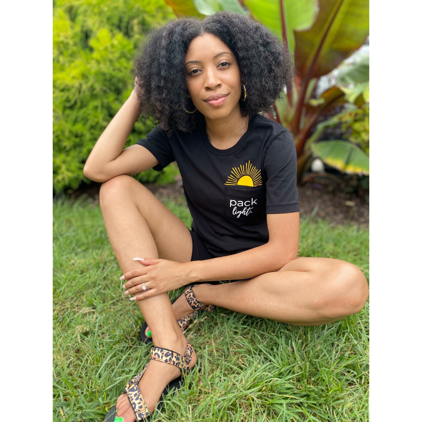 model in black Pack Light affirmation tee from Sol Rise Essentials